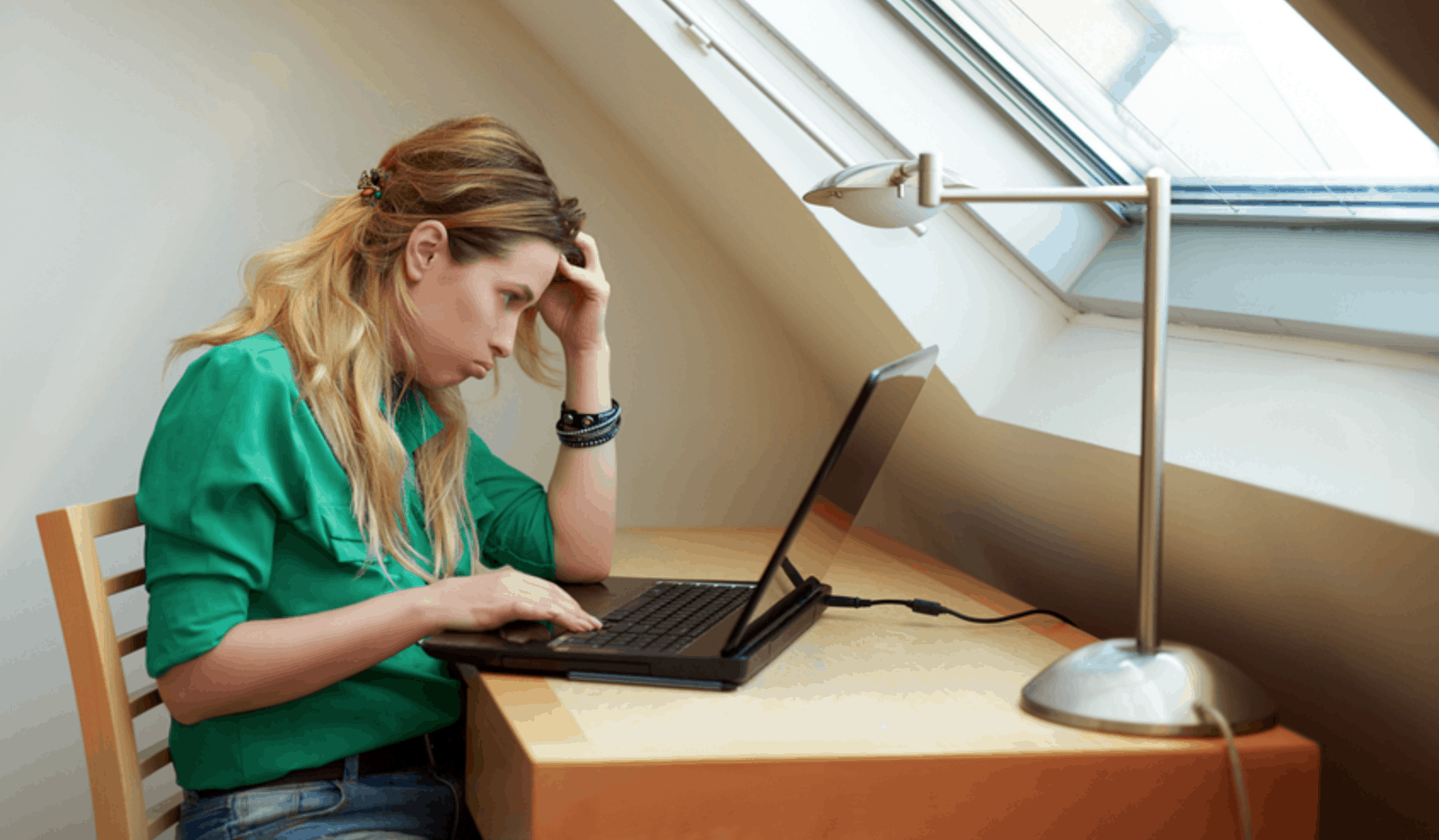 frustrated woman in front of a laptop