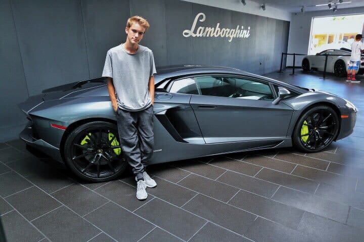 Tanner Braungardt posing next to a Lamborghini. 