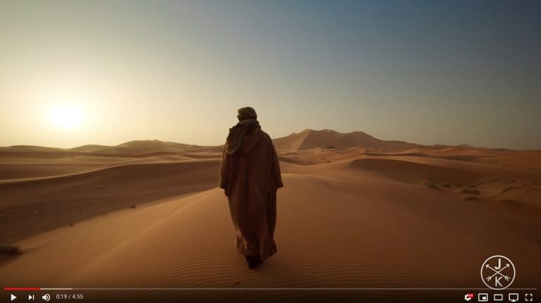 man walking in the desert