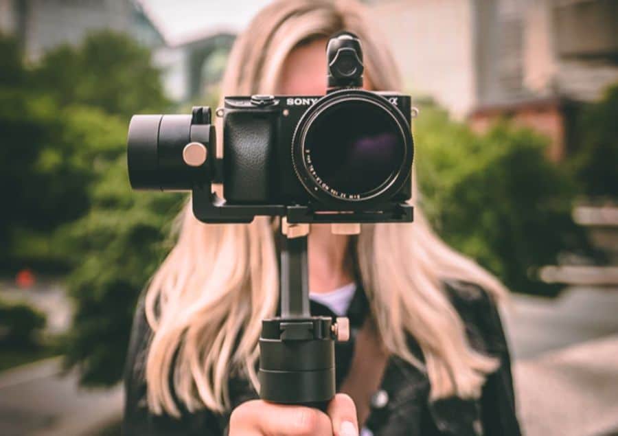 woman with camera pointing forward
