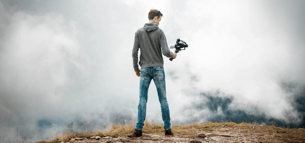 Man holding camera in front of haze