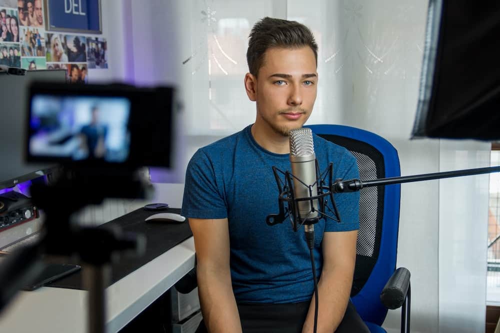 teenager sitting filming in front of a camera