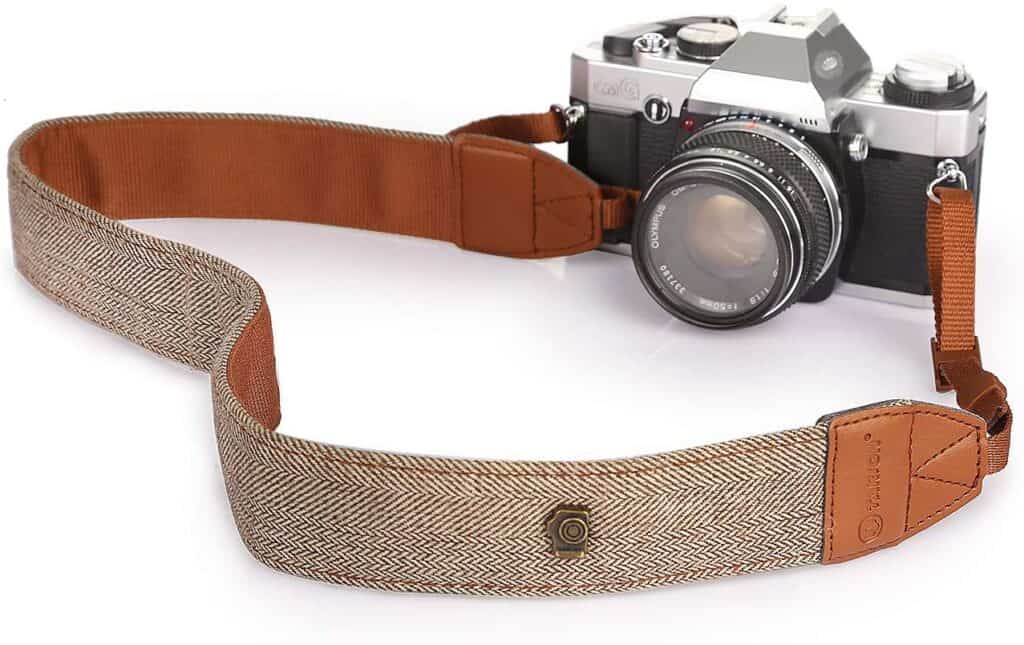 vintage camera strap attached to a digital retro camera