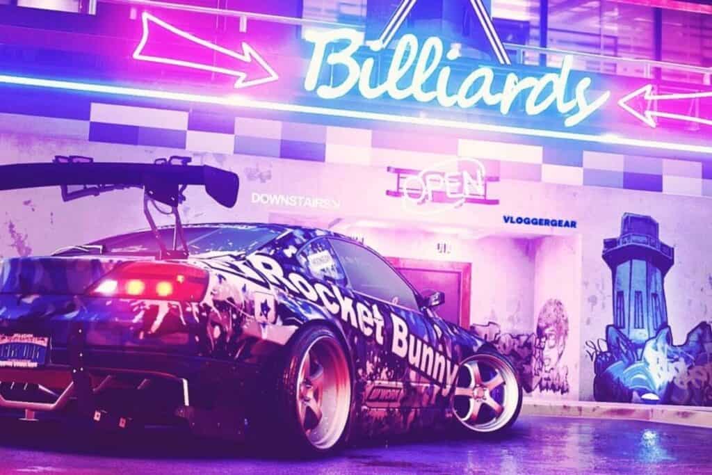 car parked under a neon sign